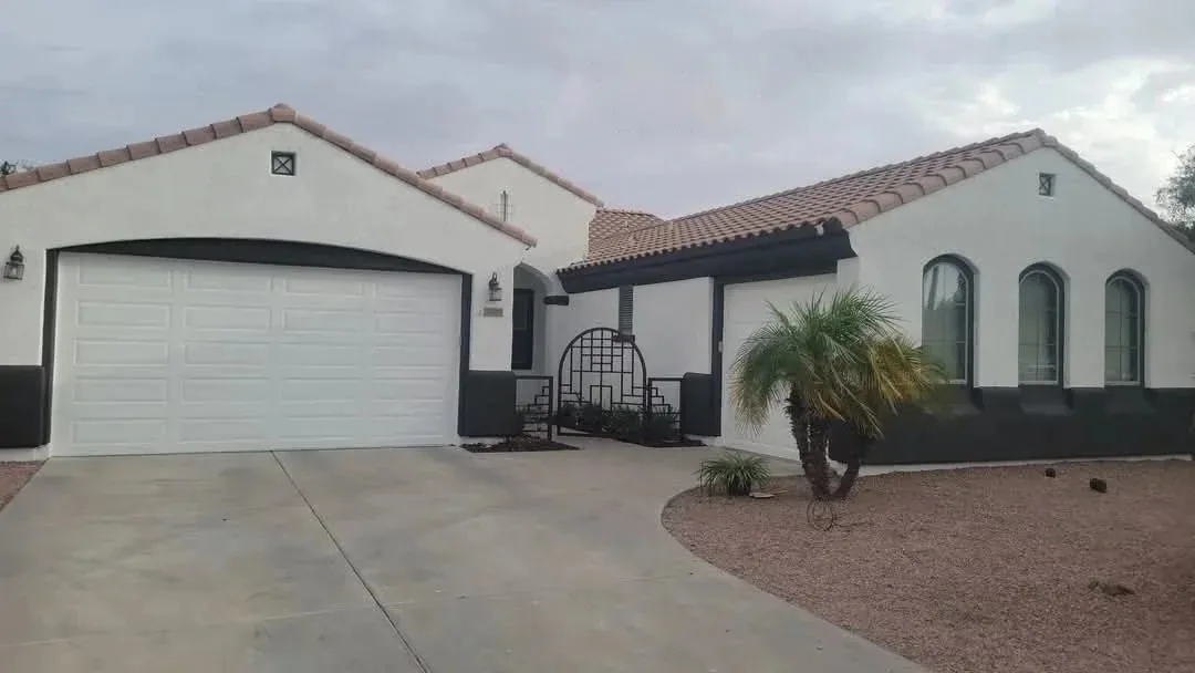 The same Peoria, Arizona home after exterior repainting with crisp white walls and black trim