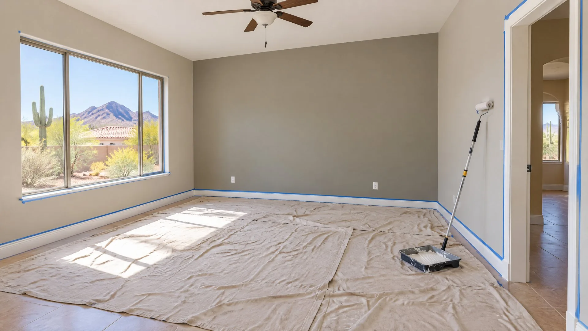 Arizona living room mid-repaint with drop cloths protecting the floor